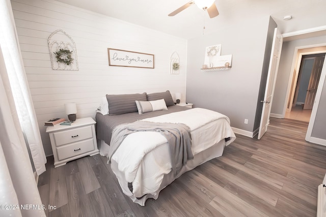 bedroom with ceiling fan and dark wood-type flooring