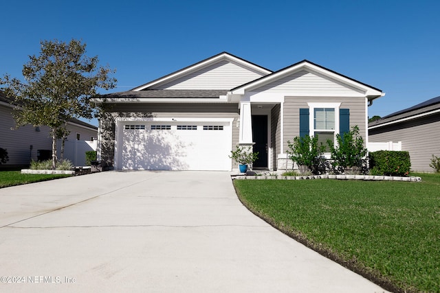 view of front of house with a front yard and a garage