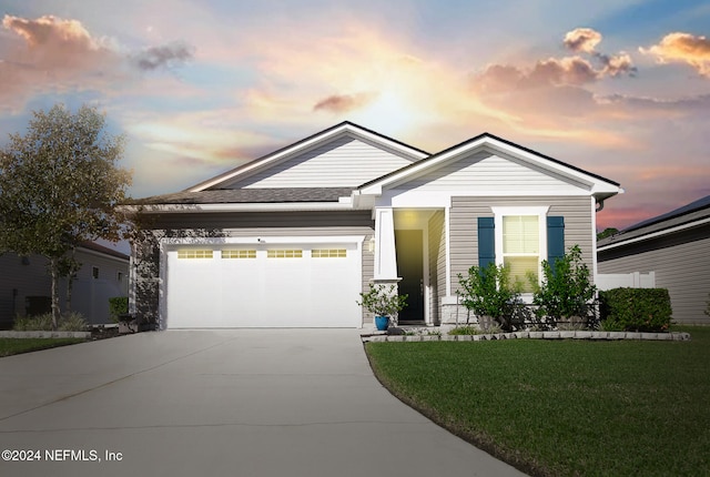 view of front facade featuring a garage and a lawn