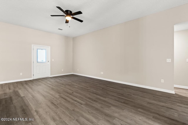 unfurnished room featuring a textured ceiling, ceiling fan, and dark hardwood / wood-style flooring