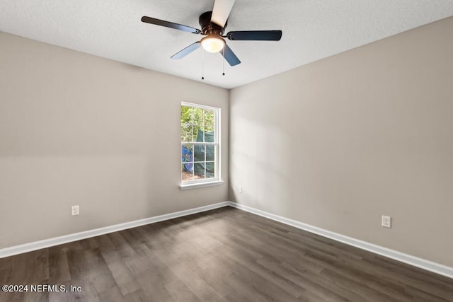 unfurnished room featuring dark wood-type flooring, a textured ceiling, and ceiling fan