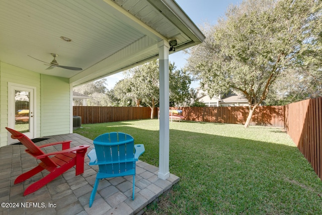 view of yard featuring central AC unit, a ceiling fan, a patio area, and a fenced backyard