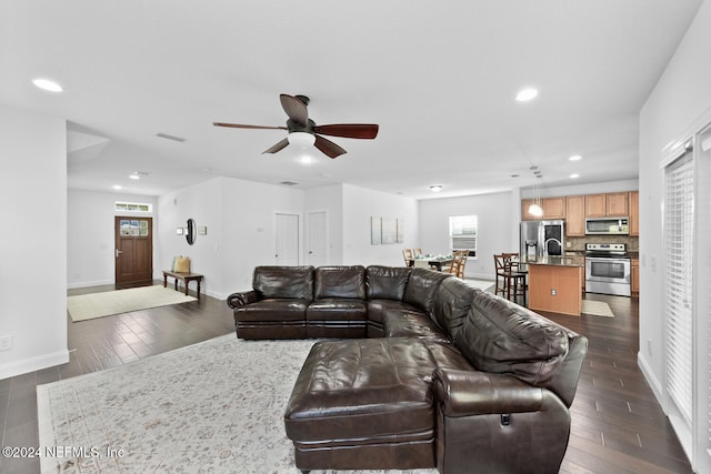 living room featuring plenty of natural light, dark wood-style floors, and recessed lighting