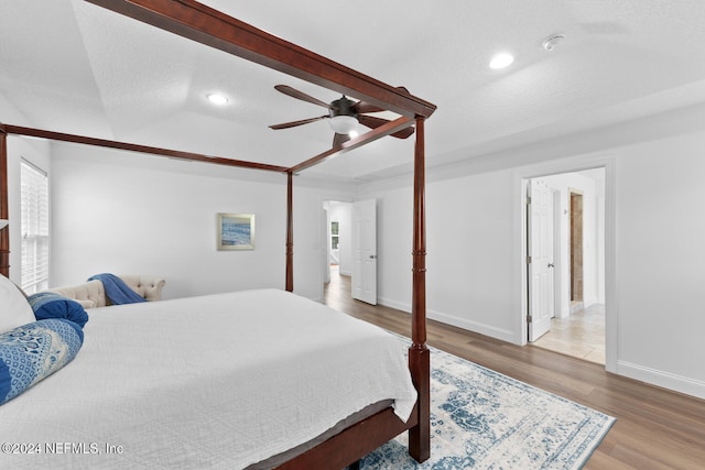 bedroom featuring wood finished floors, baseboards, recessed lighting, a textured ceiling, and ceiling fan