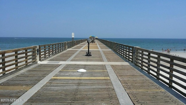 dock area with a water view and a view of the beach