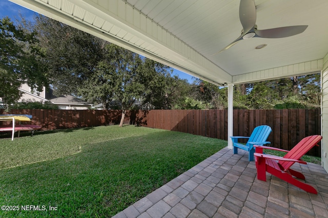 view of yard featuring a ceiling fan, a patio area, and a fenced backyard