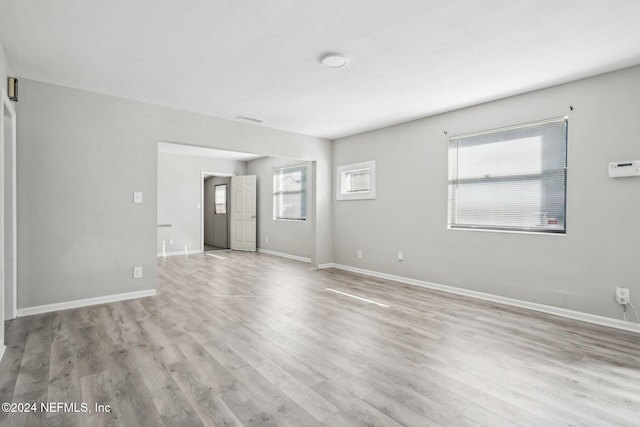 empty room featuring plenty of natural light and light hardwood / wood-style flooring