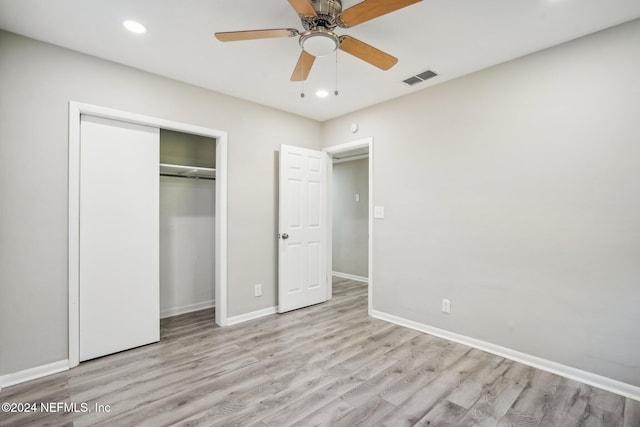 unfurnished bedroom featuring ceiling fan, a closet, and light hardwood / wood-style flooring