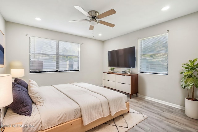 bedroom with light hardwood / wood-style flooring and ceiling fan