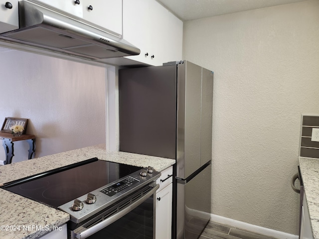 kitchen featuring white cabinetry, light stone countertops, hardwood / wood-style floors, and stainless steel range with electric cooktop