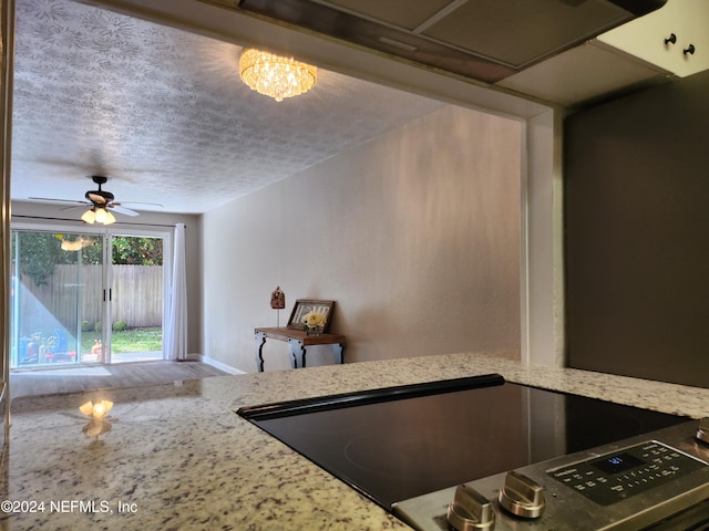 kitchen featuring black range, a textured ceiling, and ceiling fan