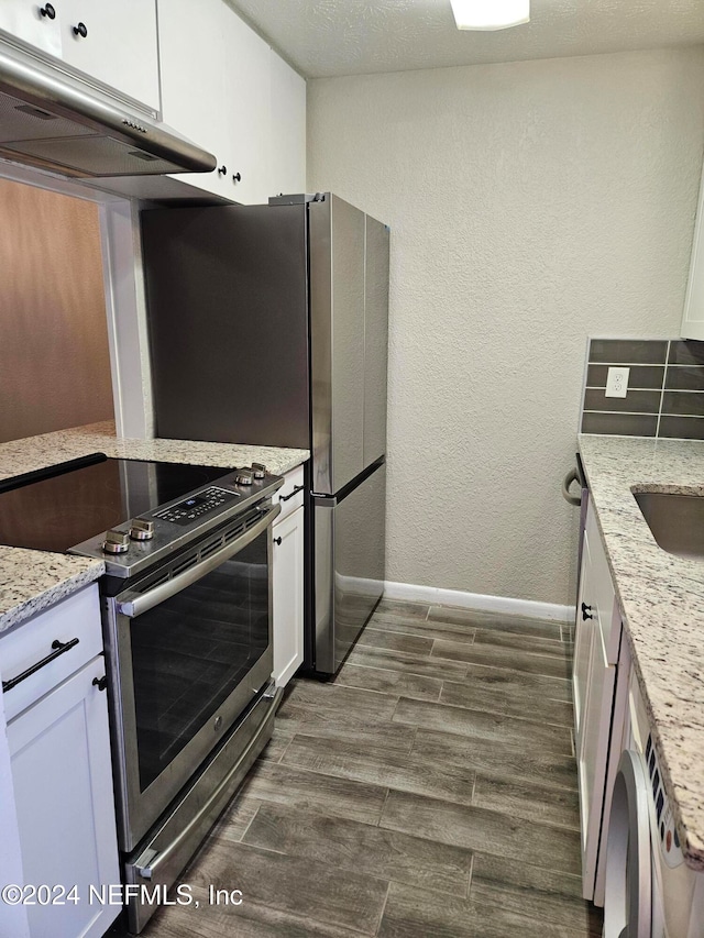 kitchen with stainless steel electric stove, light stone counters, white cabinetry, and dark hardwood / wood-style floors