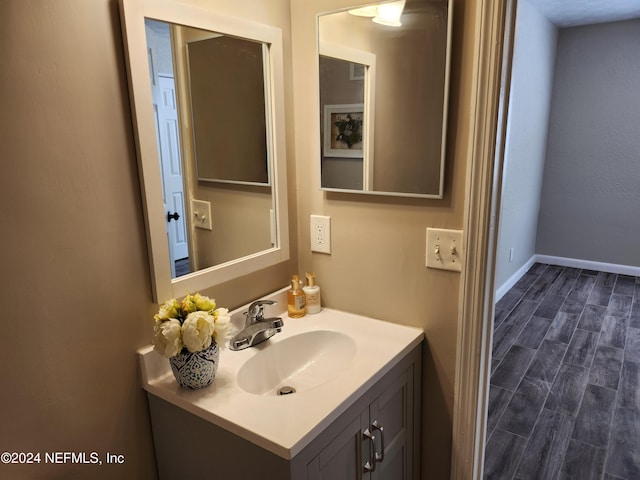 bathroom featuring vanity and hardwood / wood-style floors