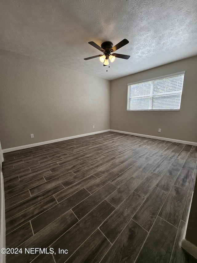 4836 Atlantic Blvd Unit 106, Jacksonville, FL 32207 - unfurnished room featuring dark wood-style floors, ceiling fan, and a textured ceiling