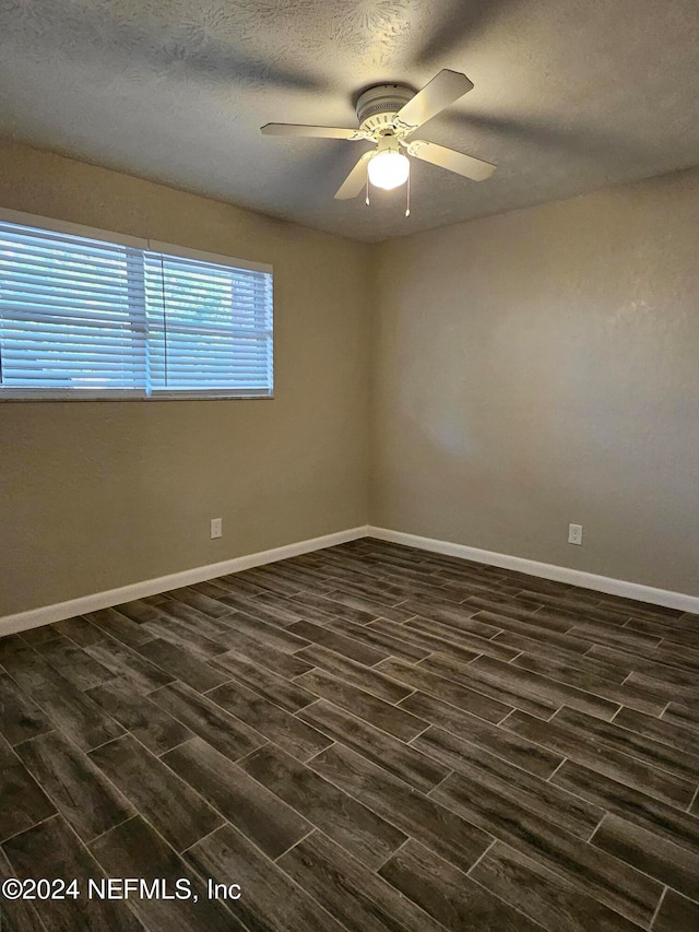 unfurnished room featuring dark hardwood / wood-style floors, a textured ceiling, and ceiling fan