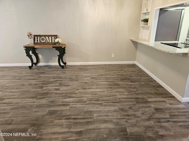 dining space with dark wood-type flooring and built in shelves