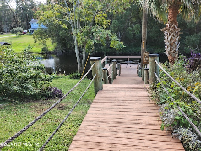 exterior space featuring a yard and a water view