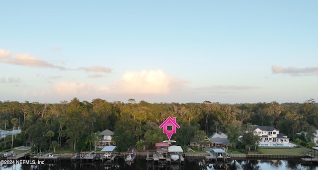 aerial view at dusk featuring a water view