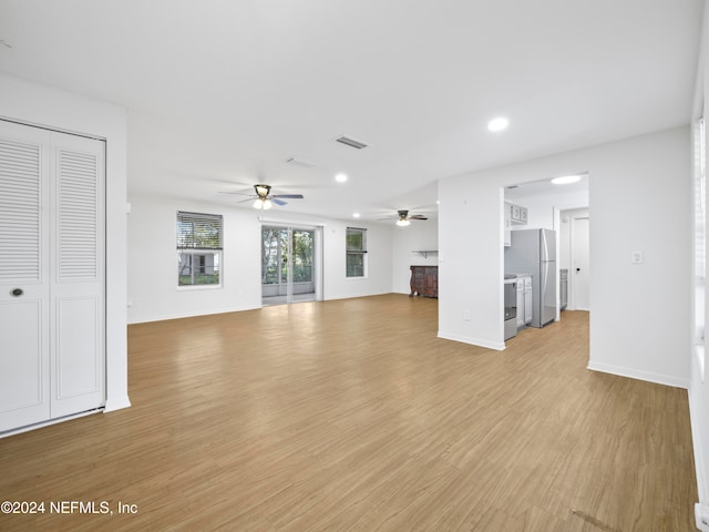 unfurnished living room featuring light hardwood / wood-style flooring and ceiling fan