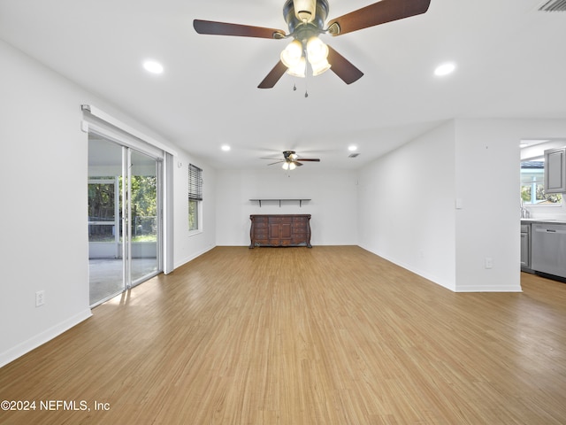 unfurnished living room with ceiling fan and light wood-type flooring