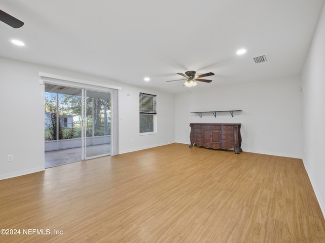 unfurnished living room featuring light wood-type flooring and ceiling fan