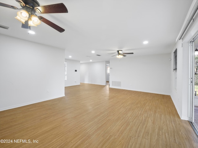 unfurnished living room with light hardwood / wood-style floors and ceiling fan