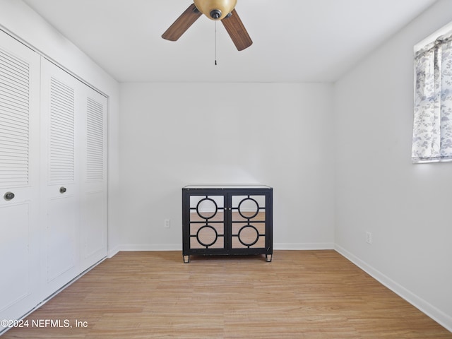 unfurnished bedroom featuring a closet, ceiling fan, and light wood-type flooring