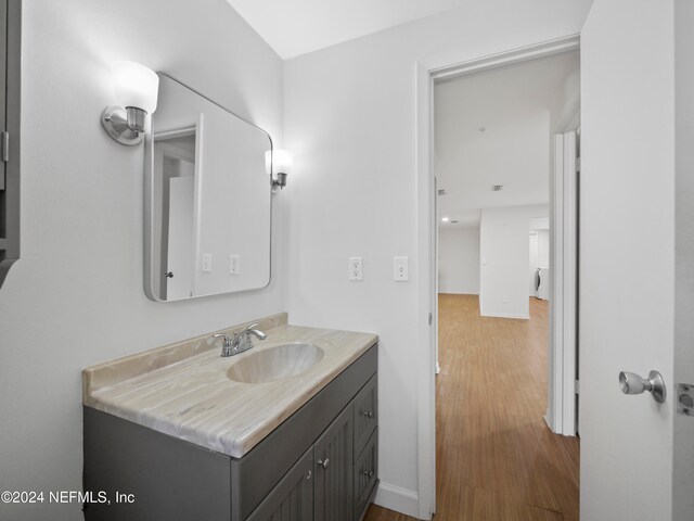 bathroom featuring vanity and hardwood / wood-style floors