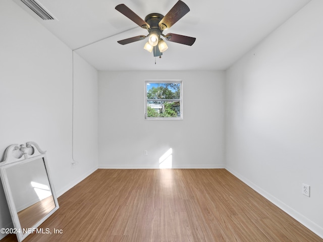 spare room featuring wood-type flooring and ceiling fan