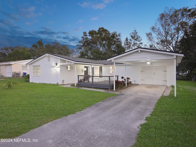 single story home featuring a yard and a garage