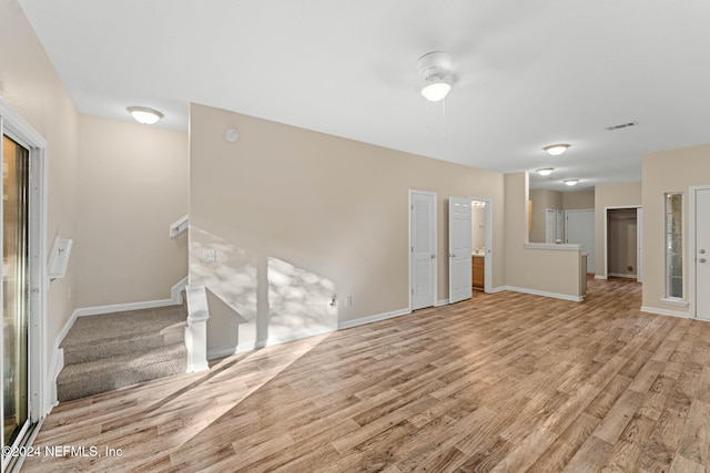 unfurnished living room featuring light hardwood / wood-style flooring and ceiling fan