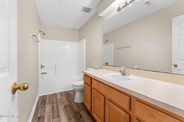 full bathroom with toilet, shower / tub combination, vanity, and hardwood / wood-style floors