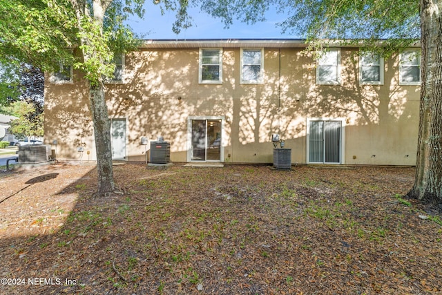 rear view of property featuring central air condition unit