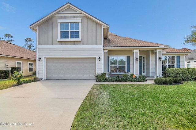 view of front of home with a front lawn and a garage