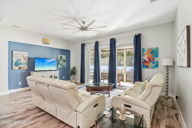 living room with light hardwood / wood-style floors and ceiling fan