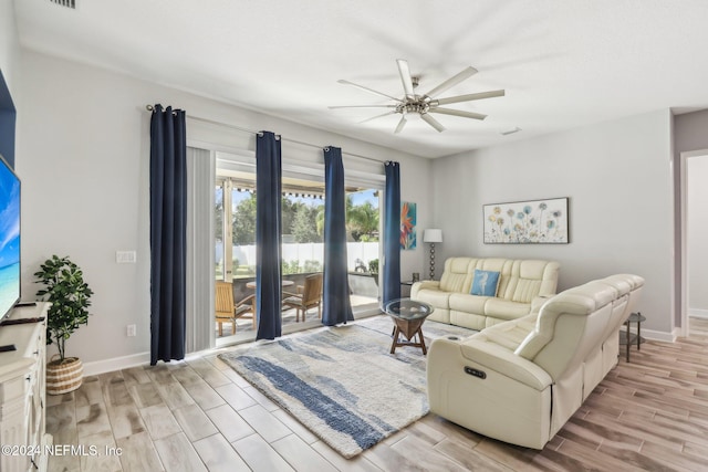 living room with light hardwood / wood-style floors and ceiling fan