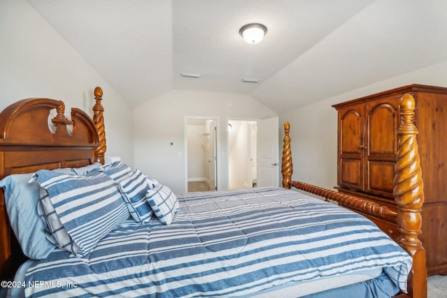 carpeted bedroom with vaulted ceiling