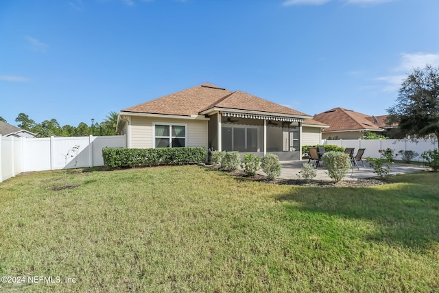 back of house featuring a patio, a sunroom, and a yard