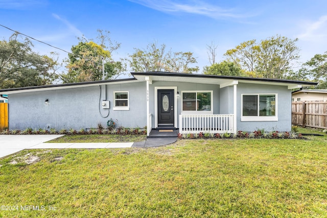 ranch-style house featuring a porch and a front lawn