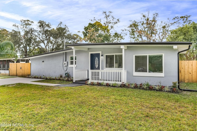 single story home with a porch and a front yard