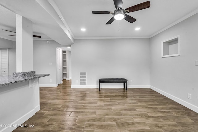 unfurnished living room featuring hardwood / wood-style floors, ceiling fan, and crown molding