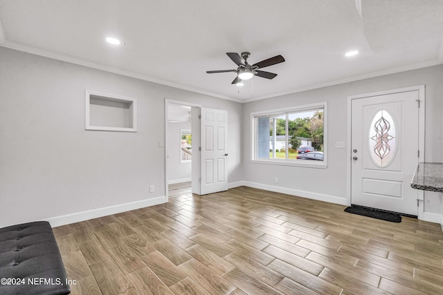 foyer with ceiling fan, light hardwood / wood-style floors, and ornamental molding