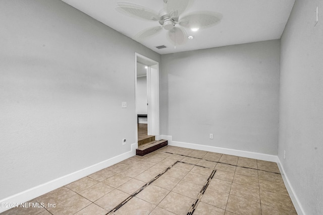 spare room featuring ceiling fan and light tile patterned flooring