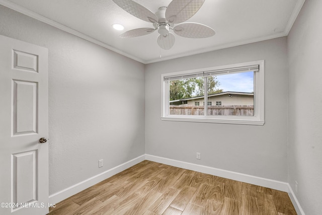 unfurnished room with ceiling fan, light wood-type flooring, and ornamental molding