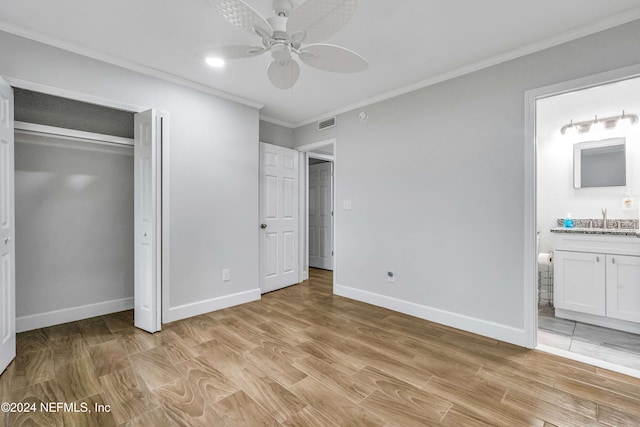 unfurnished bedroom featuring ensuite bathroom, sink, crown molding, ceiling fan, and light hardwood / wood-style floors