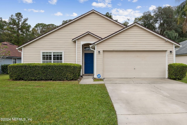 view of front of property with a front yard and a garage