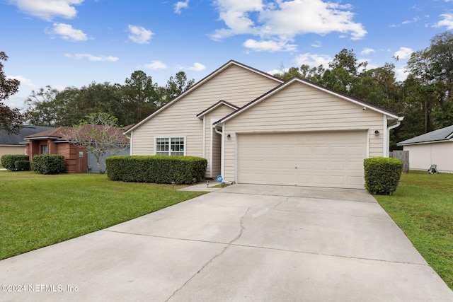 view of front of home with a front yard and a garage