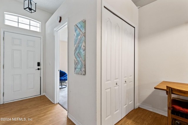 foyer with light hardwood / wood-style floors and a textured ceiling