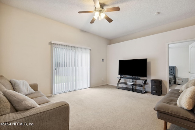 carpeted living room featuring a textured ceiling and ceiling fan