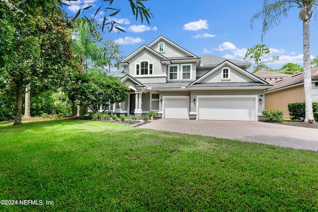 craftsman house featuring a front yard and a garage